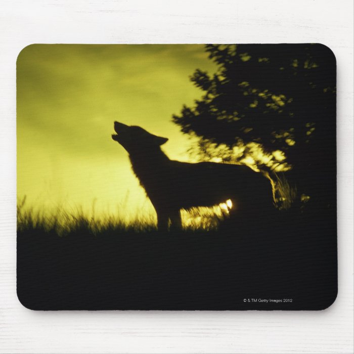Silhouette of wolf howling mouse pads