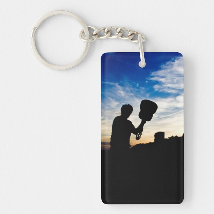 Silhouette to guitar to player with cloudy sky keychains