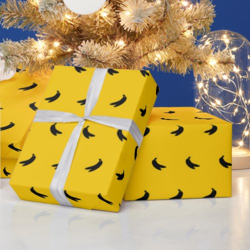 Silhouettes of Small Black Bananas on Yellow Wrapping Paper