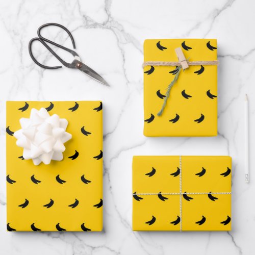 Silhouettes of Small Black Bananas on Yellow Wrapping Paper Sheets