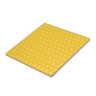 Silhouettes of Small White Bananas on Yellow Ceramic Tile