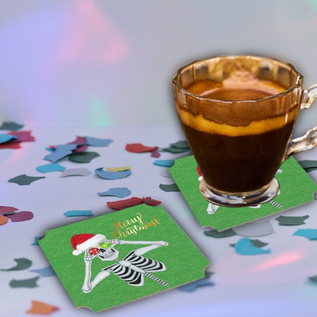 Silly Christmas Skeleton Ornament Eyes Santa Hat Paper Coaster (Cute Merry Christmas skeleton ornaments Santa hat on green paper party drink coasters.)