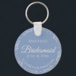 Silver Lace Bridesmaid Periwinkle Blue Wedding Keychain<br><div class="desc">These beautiful bridesmaid keychains are designed to be given as a gift or wedding favor. The design is simple yet elegant and features a frilly silver gray faux foil border with pale gray text on a dusty periwinkle blue background. There is space for her name, the wedding date and the...</div>