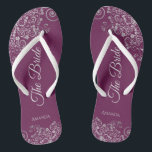 Silver Lace on Cassis Purple The Bride Wedding Flip Flops<br><div class="desc">Dance the night away with these beautiful wedding flip flops. Designed for the bride, they feature a simple yet elegant design with pale gray script lettering on a cassis purple, magenta, or berry colored background and fancy silver gray lace curls and swirls. Beautiful way to stay fancy and appropriate while...</div>