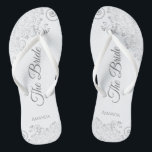 Silver Lace on White Elegant The Bride Wedding Flip Flops<br><div class="desc">Dance the night away with these beautiful wedding flip flops. Designed for the bride, they feature a simple yet elegant design with grey script lettering on a white background and fancy silver gray lace curls and swirls. Beautiful way to stay fancy and appropriate while giving your feet a break after...</div>