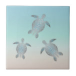 Silver Sea Turtle Beach Ceramic Tile<br><div class="desc">Introducing our exquisite Hawaiian Turtle Tile, a harmonious blend of traditional tribal artistry and modern aesthetics. The centerpiece of the tile showcases the graceful silhouettes of Hawaii's iconic sea turtles, rendered in a shimmering silver-blue hue that captivates the eye. The backdrop of the tile presents a captivating abstract representation of...</div>