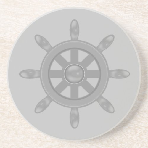 Silver ship wheel on light gray coaster