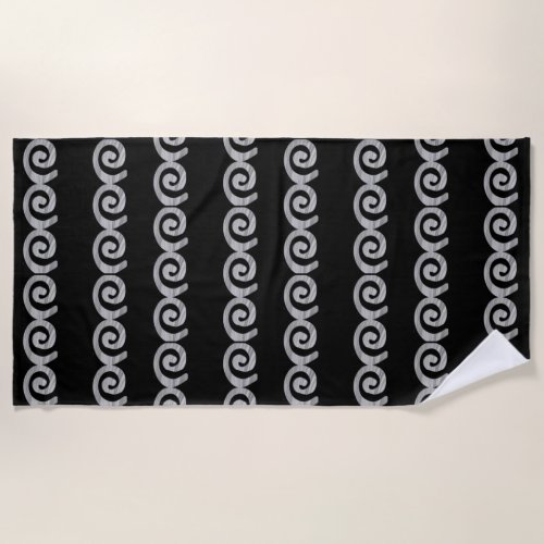 Silver spirals pattern on black beach towel