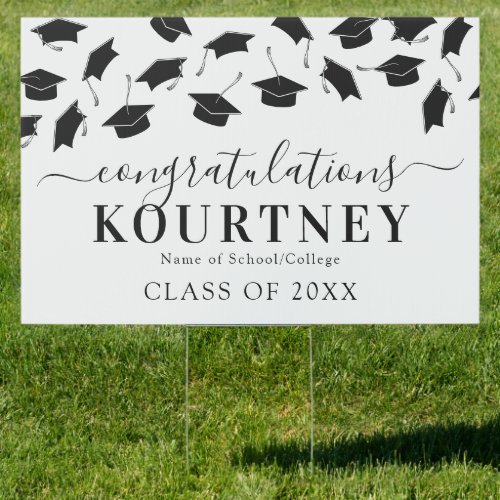 Simple 2022 Congratulations Graduate Sign - Modern graduation yard sign featuring a simple white background that can be changed to any color, falling black mortarboard caps, and a congratulations text template that is easy to personalize.