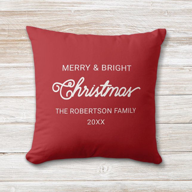 Simple Modern Script Red Merry Christmas Wishes Throw Pillow (Red and white, modern script "Merry and Bright" Christmas pillow with custom family name and year.)