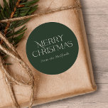 Simple Stylish Merry Christmas | Name | Green Classic Round Sticker<br><div class="desc">These stylish Christmas stickers feature simple,  stylish typography reading,  "Merry Christmas" in ivory. A text template is included for easy personalization. The background color (dark green) can be customized to any color you'd like. Great for envelope seals,  gift tag stickers,  party favor stickers,  and more!</div>