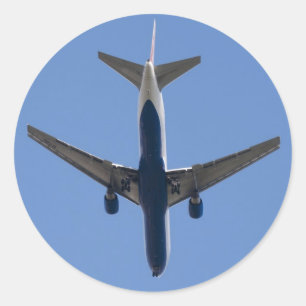 Single airplane on the blue sky background classic round sticker