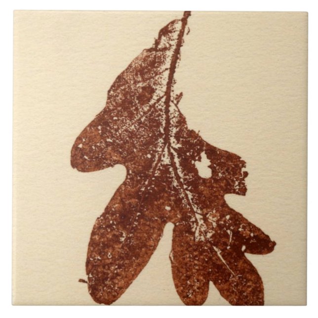 Single oak leaf nature printed in brown ink on tan ceramic tile (Front)