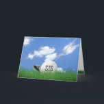 Sister's birthday golf ball in grass card<br><div class="desc">White golf ball in green grass with golf club and sky background for sister's birthday.</div>