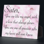 Sisters greatest love plaque<br><div class="desc">Done on a pink feather background "Sister, you are like my angel, with a love that always glows. You are one of the greatest gifts my heart will ever know."</div>