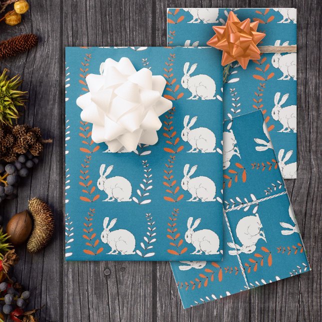 sitting elegant White Rabbit Flowers Dark Blue Wrapping Paper Sheets (Rows of white rabbits with orange and white flower plants on roll of dark blue wrapping paper.)