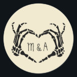 Skeleton Hands Heart Shape Custom Wedding Classic Round Sticker<br><div class="desc">Add a creepy, personalized touch to your wedding with these stickers. These round stickers are perfect for using as envelope seals when sending out wedding invitations or for decorating party favors. They are a cream or ivory color and feature an illustration of skeleton hands in a heart shape framing the...</div>