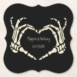 Skeleton Hands Heart Shape Custom Wedding Paper Coaster<br><div class="desc">Add a creepy, personalized touch to your wedding with these paper coasters. These disposable coasters are black and feature an illustration of skeleton hands in a heart shape framing the bride and groom's names and wedding date. The graphic and text are in a cream or ivory color. The macabre style...</div>