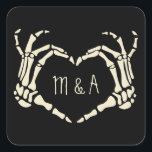Skeleton Hands Heart Shape Custom Wedding Square Sticker<br><div class="desc">Add a creepy, personalized touch to your wedding with these stickers. These square stickers make great envelope seals for sending wedding invitations or can be used to decorate party favors. They are black and feature an illustration of skeleton hands in a heart shape framing the bride and groom's first initials....</div>