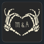 Skeleton Hands Heart Shape Custom Wedding Square Sticker<br><div class="desc">Add a creepy, personalized touch to your wedding with these stickers. These square stickers make great envelope seals for sending wedding invitations or can be used to decorate party favors. They are black and feature an illustration of skeleton hands in a heart shape framing the bride and groom's first initials....</div>