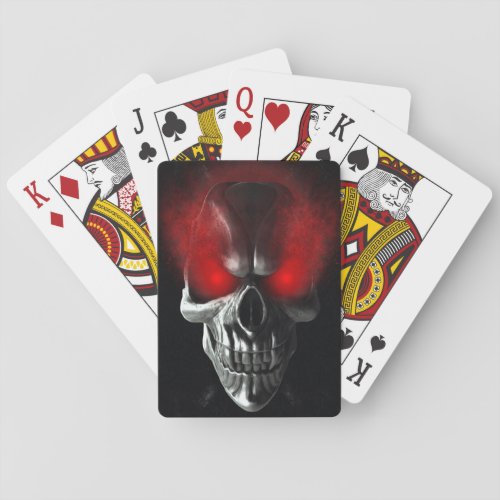 Skull with glowing red eyes playing cards