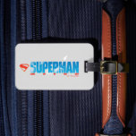 Skybound Superman Silhouette Luggage Tag<br><div class="desc">Let your imagination soar with this uplifting Superman design that captures the magic of flight! The bold blue “SUPERMAN” typography is filled with fluffy white clouds, creating the illusion of the open sky itself. A dynamic silhouette of Superman streaks upward from the letters, trailing a graceful arc of light that...</div>