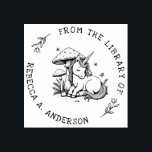 Sleeping Unicorn Toadstool Bookplate Stamp<br><div class="desc">Enchant your library with this personalized book stamp featuring a sleeping baby unicorn nestled beneath a magical toadstool. Surrounded by delicate ferns and fluttering butterflies,  this whimsical design adds a fairytale charm to every book. A dreamy gift for readers,  kids,  and lovers of fantasy and woodland magic.</div>