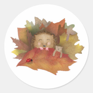 Sleepy hedgehog in a bed of leaves round stickers