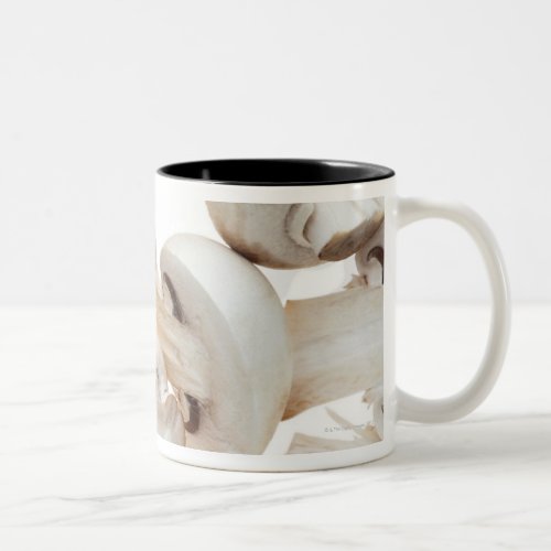 Sliced button mushrooms agaricus bisporus on Two_Tone coffee mug
