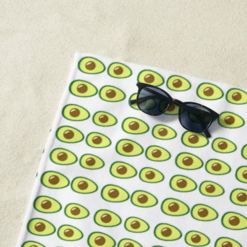 Sliced green avocado on white beach towel