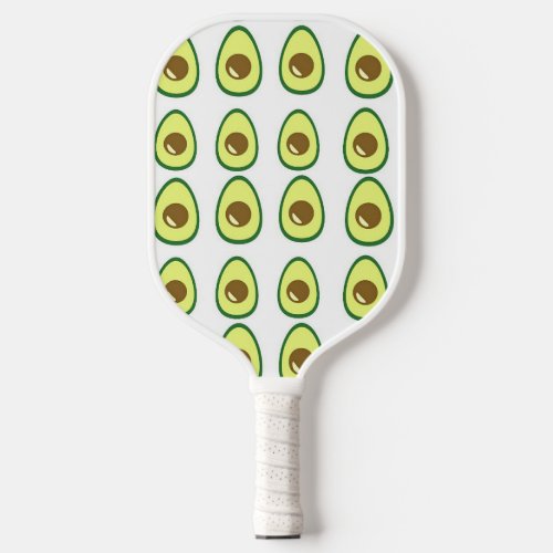 Sliced green avocado on white pickleball paddle