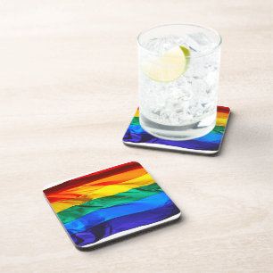 SlipperyJoe's gay pride flag waving red orange yel Beverage Coaster