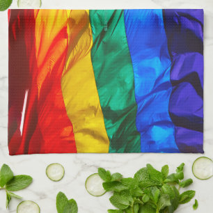SlipperyJoe's gay pride flag waving red orange yel Kitchen Towel
