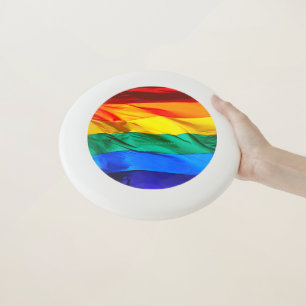 SlipperyJoe's gay pride flag waving red orange yel Wham-O Frisbee