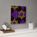 SlipperyJoe's Hanukkah-themed image golden yellow  Square Wall Clock<br><div class="desc">SlipperyJoe's Hanukkah-themed image golden yellow Star of David blue candles with orange flames Menorah-inspired art gift idea Jewish identity spirituality holiday retro bold symmetrical pattern diamond-shaped grid background blends tradition and vibrant design purple black checkerboard effect Hebrew religious celebration</div>