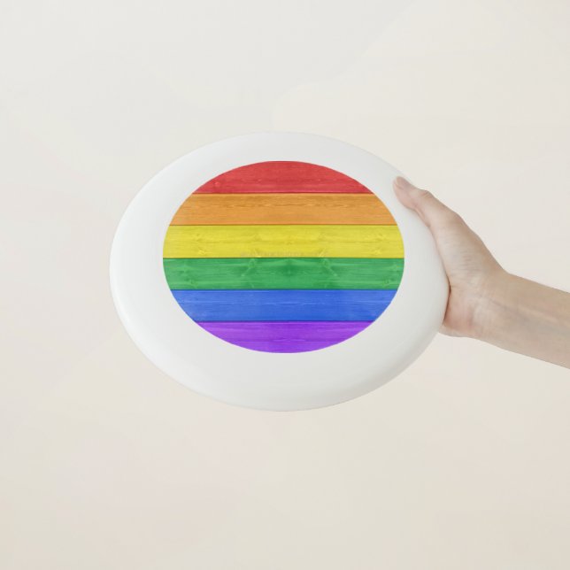 SlipperyJoe's pride wooden flag horizontal rainbow Wham-O Frisbee (In Hand)
