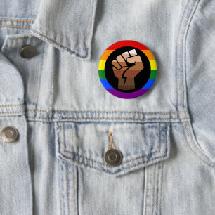 SlipperyJoe's queer people color flag raised fist Button