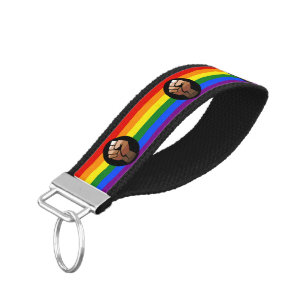 SlipperyJoe's queer people color flag raised fist Wrist Keychain