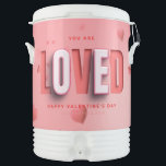 SlipperyJoe's Valentine's Day gifts romantic tone  Beverage Cooler<br><div class="desc">SlipperyJoe's Valentine's Day gifts romantic tone scattered heart shapes expressing love appreciation uplifting inclusive and affectionate tone vibrant celebratory graphic warmth affection soft pink canvas background you are loved text LGBTQIA white letters red outlines shadow artistic three-dimensional standout effect playful 3D-elements bold typography</div>