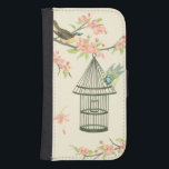 Small Birds Perched on a Branch and on a Birdcage Phone Wallet<br><div class="desc">Nancy Slocum's have painted many birds throughout the years. This image portrays two small blue and yellow birds perched on a branch surrounded by pink flowers and looking curious about a birdcage. Get this cool bird-themed art piece on your Zazzle product today.</div>