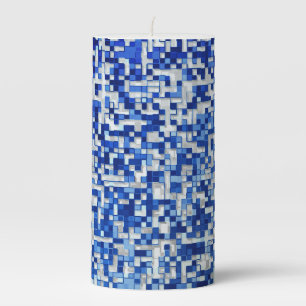 Small squares overlap, shades of blue with white pillar candle