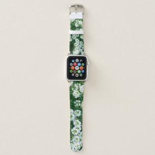 Small white flowers in the grass in the daytime in apple watch band