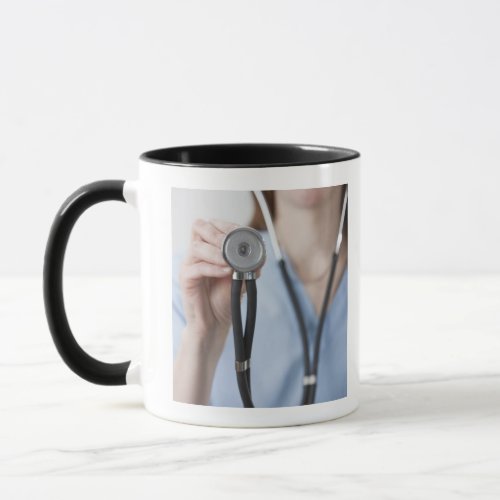 Smiling female doctor with stethoscope mug