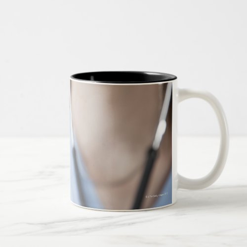 Smiling female doctor with stethoscope Two_Tone coffee mug