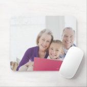 Smiling grandparents reading cookbook with mouse pad (With Mouse)