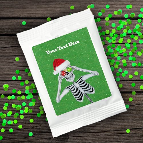 Smiling Skeleton Holding Shiny Ornaments on Green Hot Chocolate Drink Mix