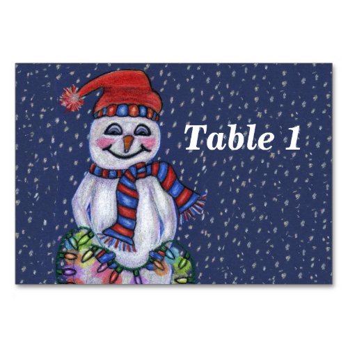 Smiling Snowman Holding String of Christmas Lights Table Number