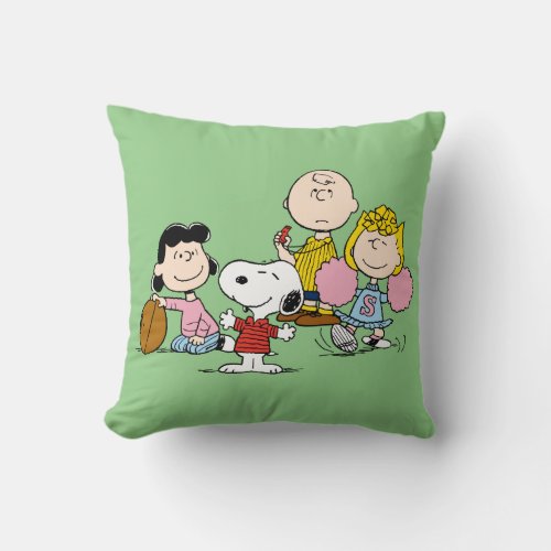 Snoopy and the Gang Play Football Throw Pillow