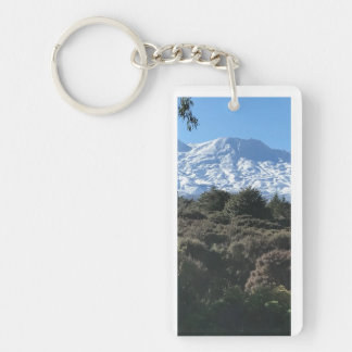 Snow-covered mountain green native bush foreground keychain