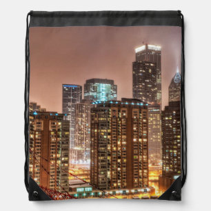 Snow falls over skyline at evening in Chicago Drawstring Bag